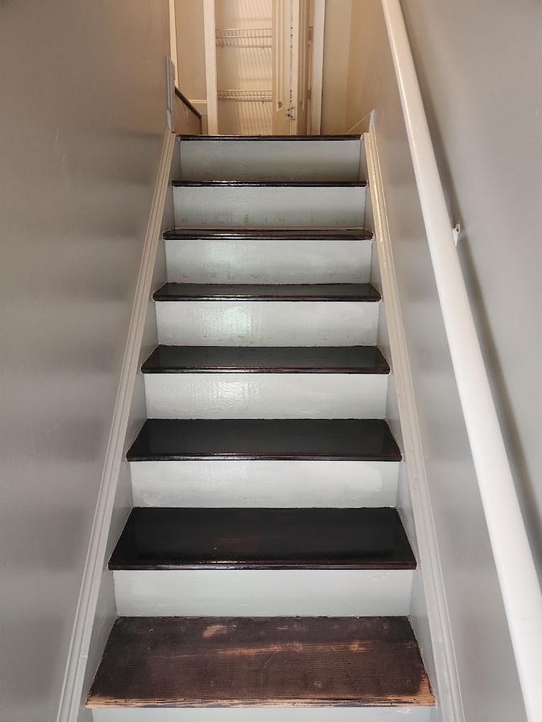 Interior wooden stairs being repaired and refinished